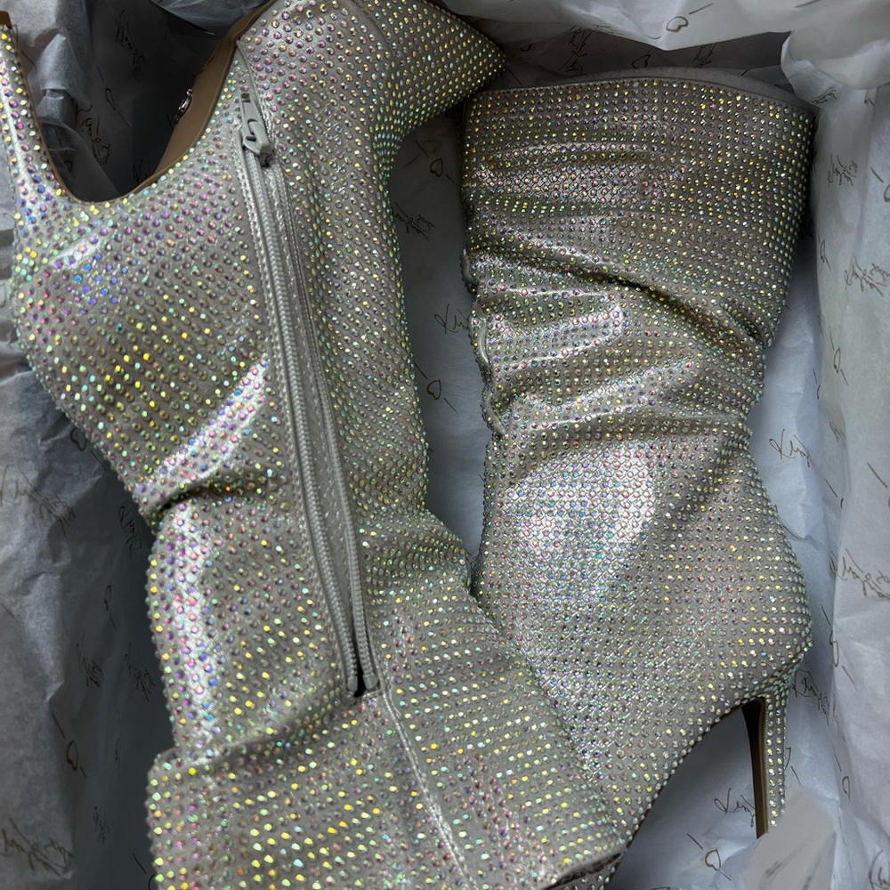 Never wore them. Beautiful, silver rhinestone heels. Side zip. 3 inch heel.